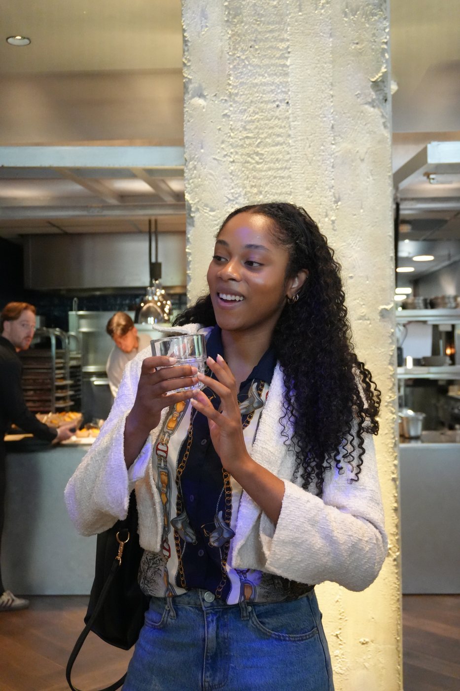 A guest with a glass in hand